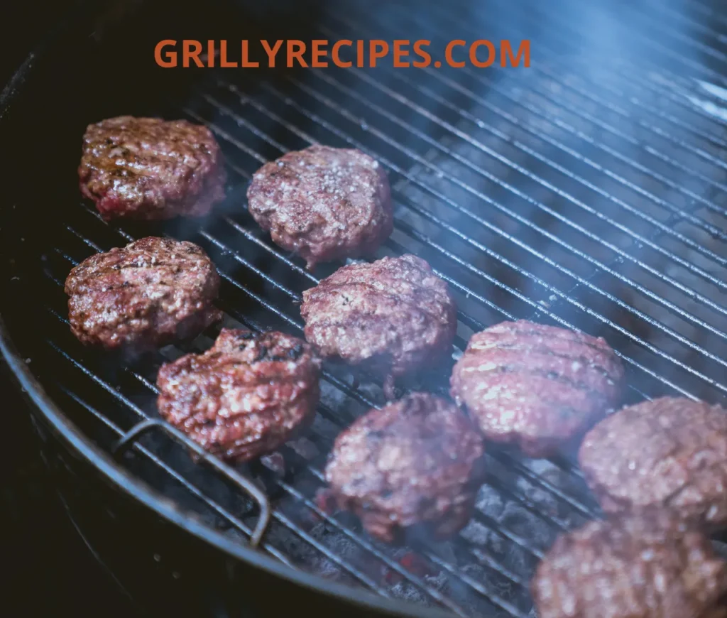 uicy beef burgers sizzling on a charcoal grill with smoke rising.