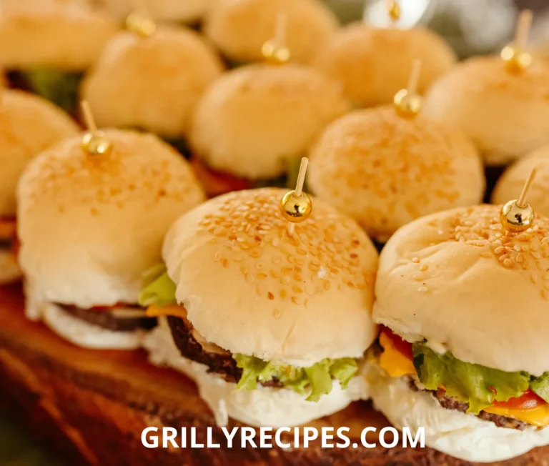 Juicy chicken sliders recipe​with melted cheese, lettuce, and pickles on toasted slider buns.