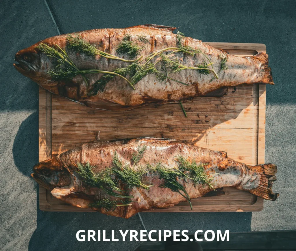 A perfectly grilled whole fish with crispy golden skin, garnished with fresh herbs and lemon slices, served on a wooden platter.
