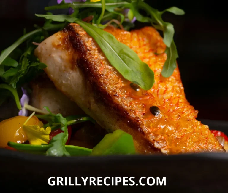 Freshly grilled branzino fillet garnished with lemon slices and herbs.