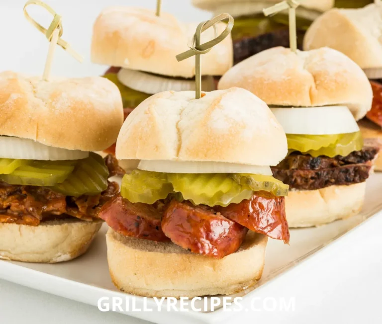 Roast beef sliders with melted cheese on soft buns, served on a wooden platter.
