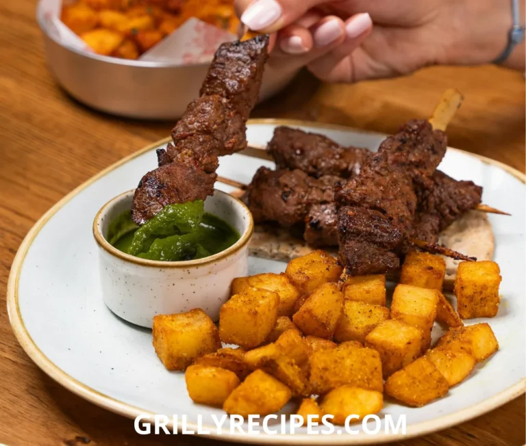 Beef and potatoes served on a rustic plate with fresh herbs.