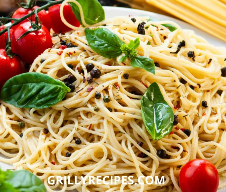 Close-up of a baked chicken spaghetti casserole with golden melted cheddar cheese and fresh parsley garnish in a white dish