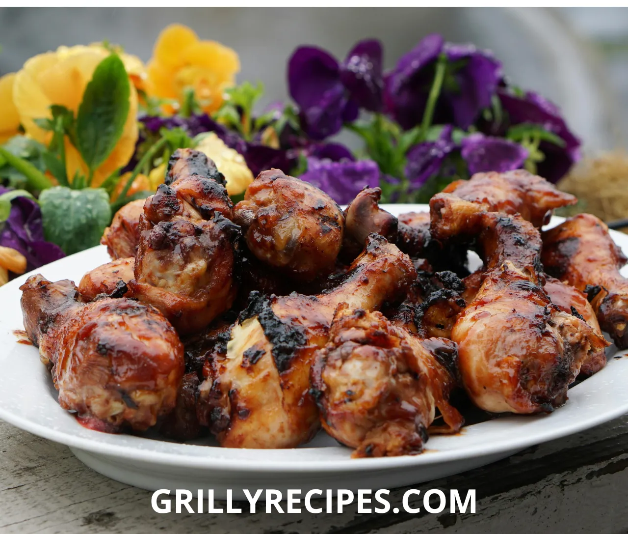 Crispy keto chicken thigh with golden skin on a plate with rosemary garnish