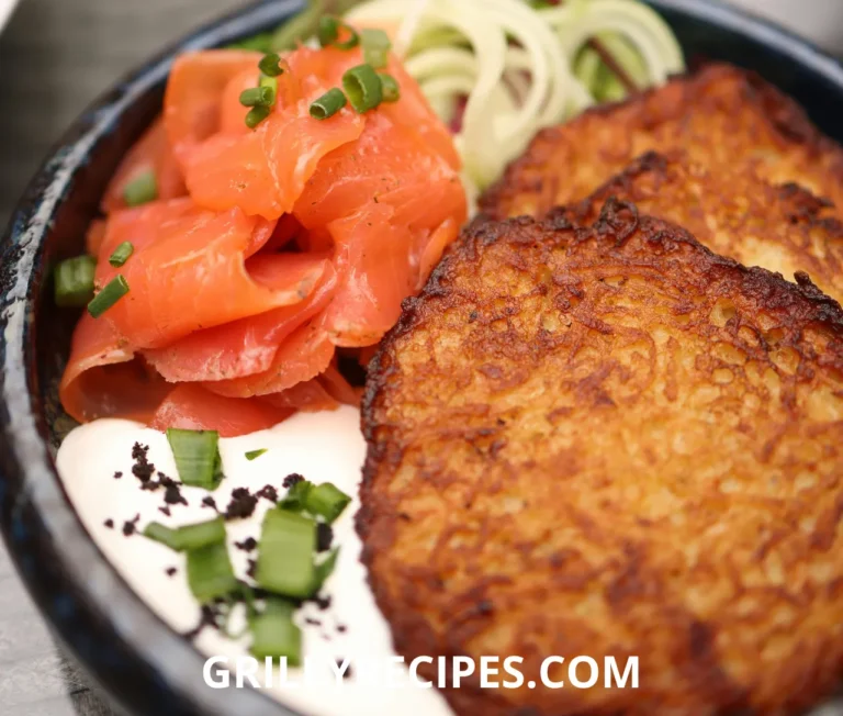 Golden red fish fillets seasoned with garlic and paprika, garnished with fresh parsley and lemon slices on a white plate, showcasing a delicious red fish recipe.