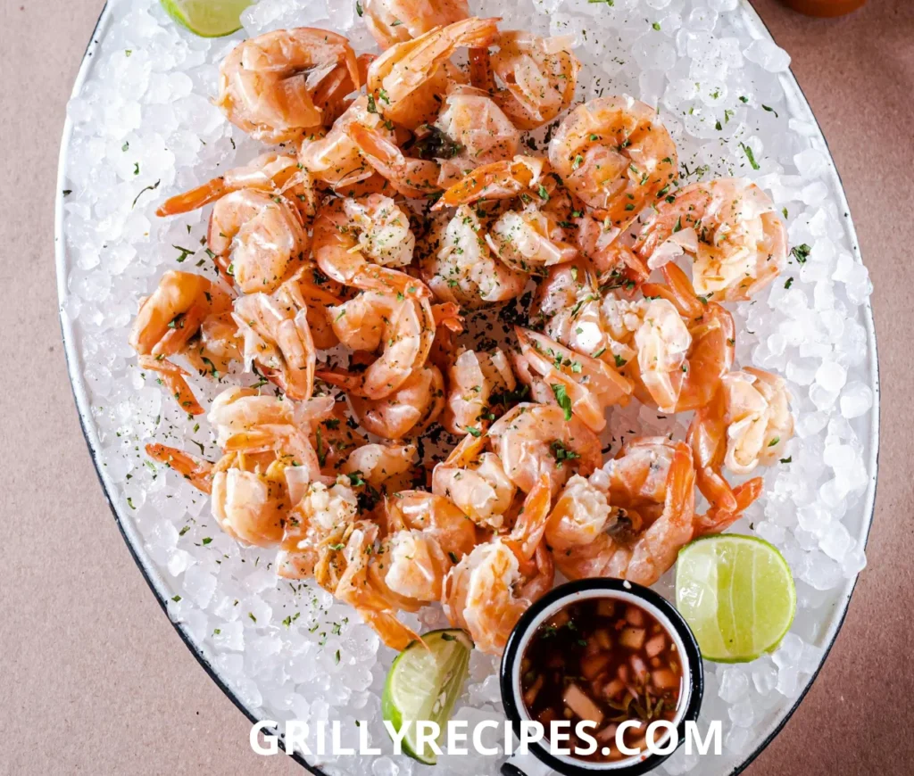 Succulent shrimp in a rich garlic butter sauce, garnished with fresh parsley and a lemon wedge on a white plate, showcasing a flavorful shrimp garlic butter recipe.