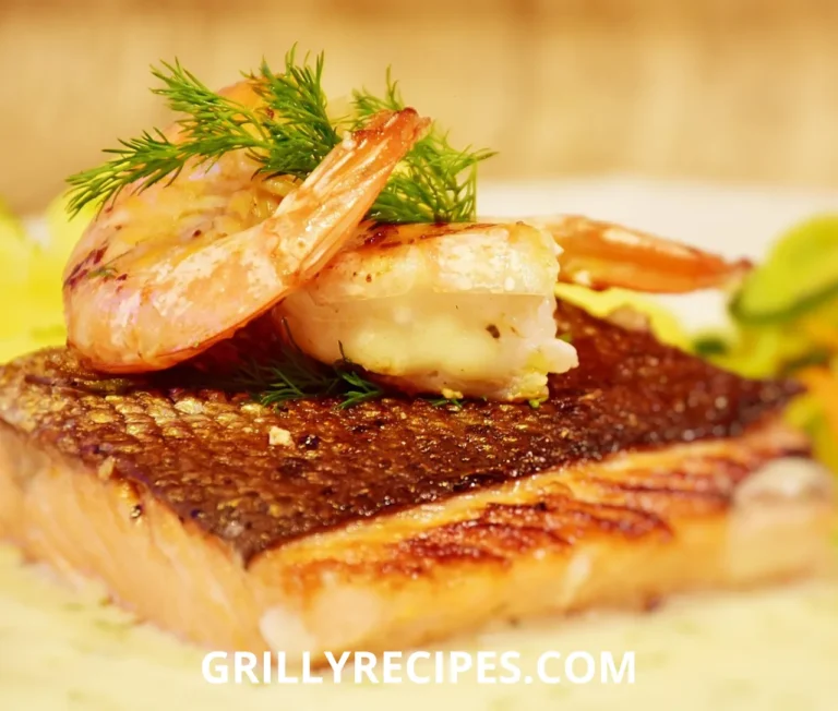 Crispy salmon and succulent shrimp in a creamy garlic sauce, garnished with fresh parsley and lemon zest in a black skillet, showcasing a luxurious salmon and shrimp recipe.