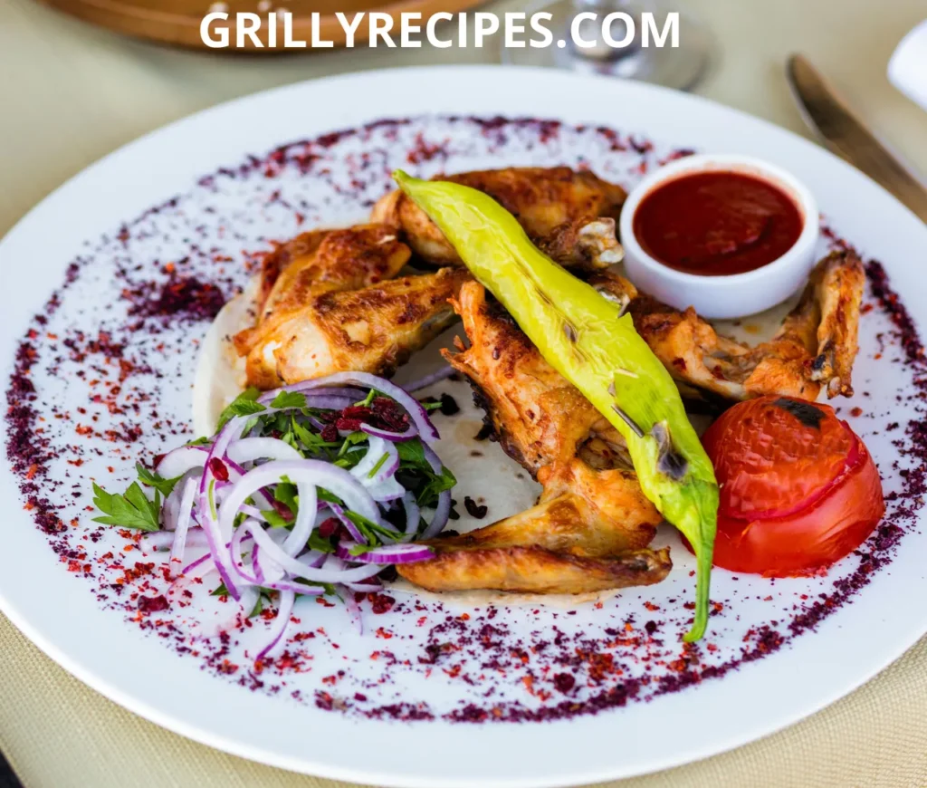 Juicy grilled chicken wings with a golden-brown char, served with dipping sauce on a wooden plate.