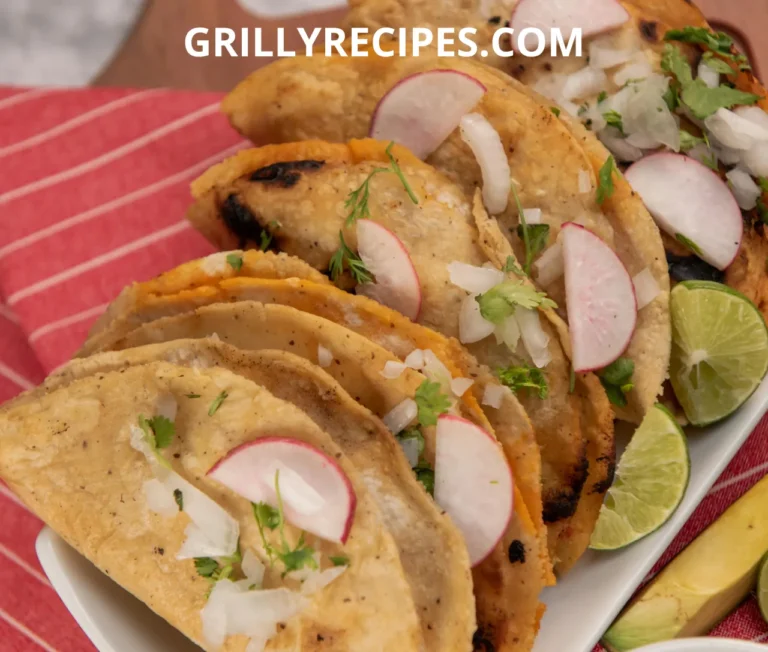 Plate of grilled fish tacos garnished with fresh radish, onion, and lime wedges.