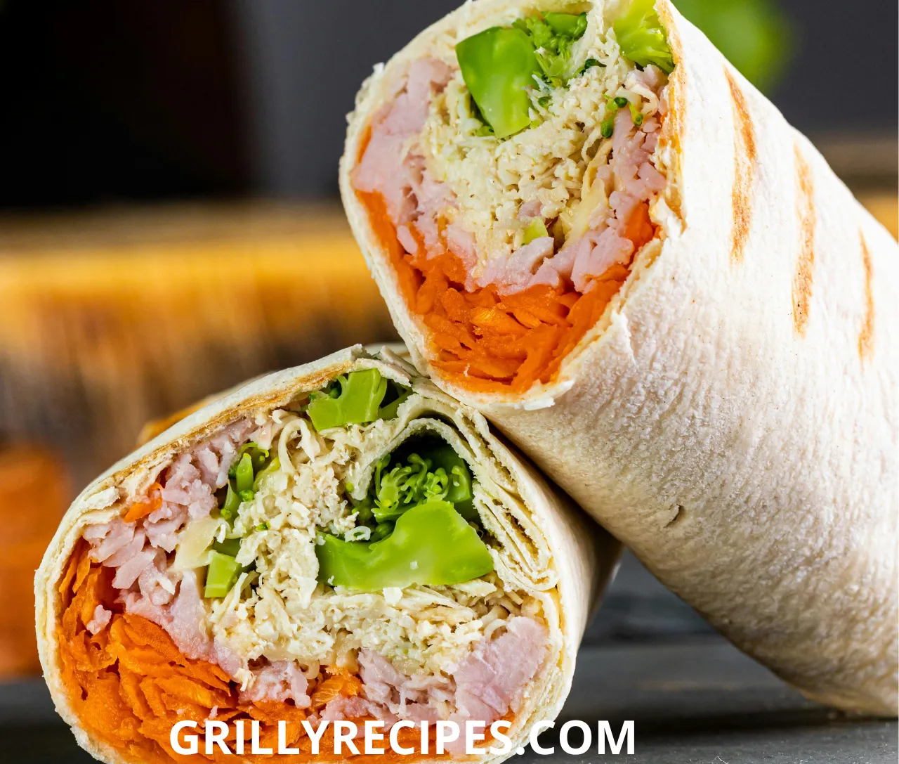 grilled chicken wrap recipe​ and vegetable wrap cut in half, revealing fresh ingredients inside.