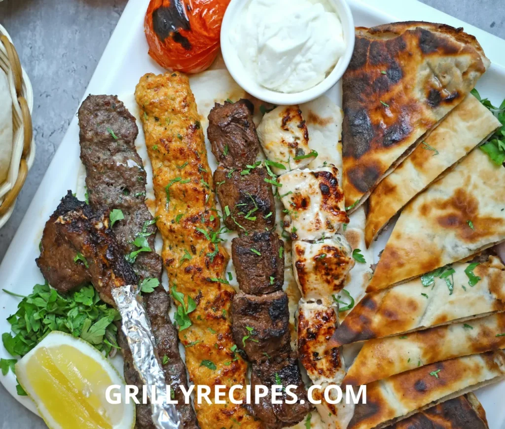 A variety of sizzling meats and vegetables cooking on a fFlat Grill Recipes.