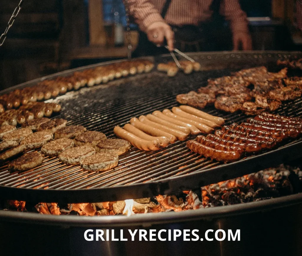 Assorted meats including sausages, burgers, and ribs grilling over an open flame.