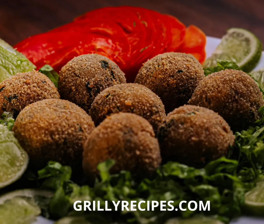grilled scallops recipe with a golden sear, served with lemon wedges and fresh herbs on a white plate.