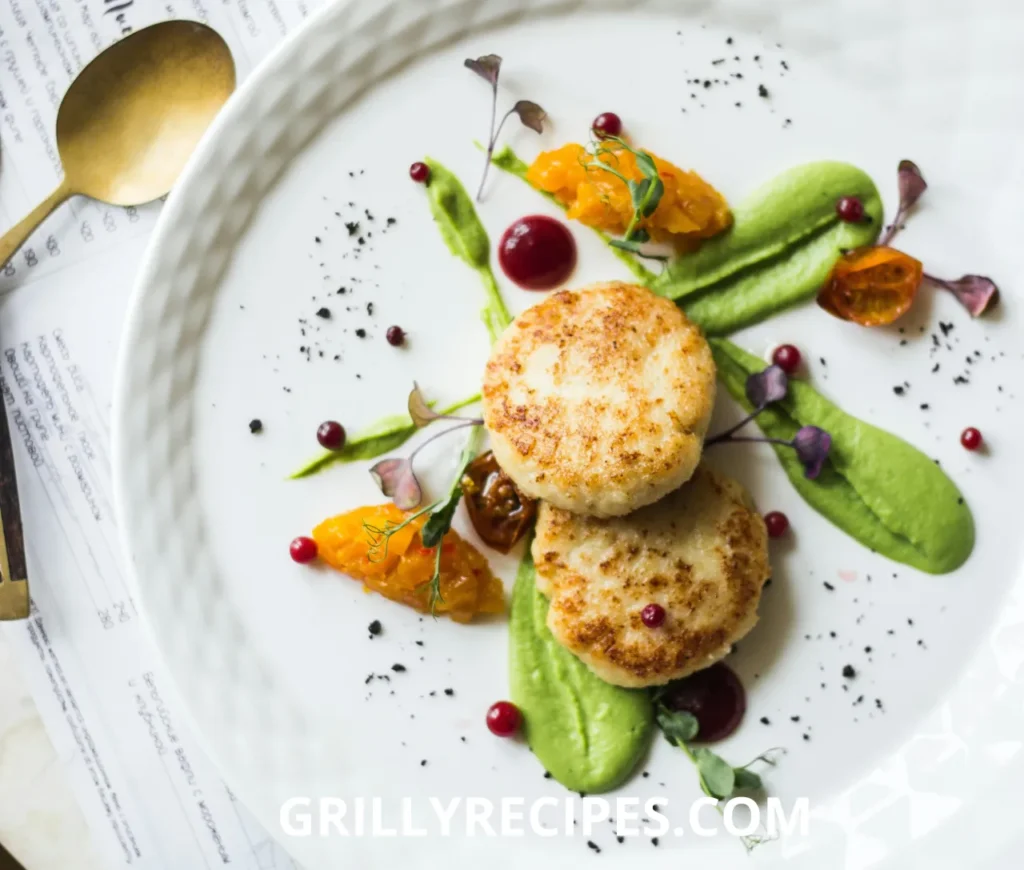 Grilled scallops with a golden sear, served with lemon wedges and fresh herbs on a white plate.