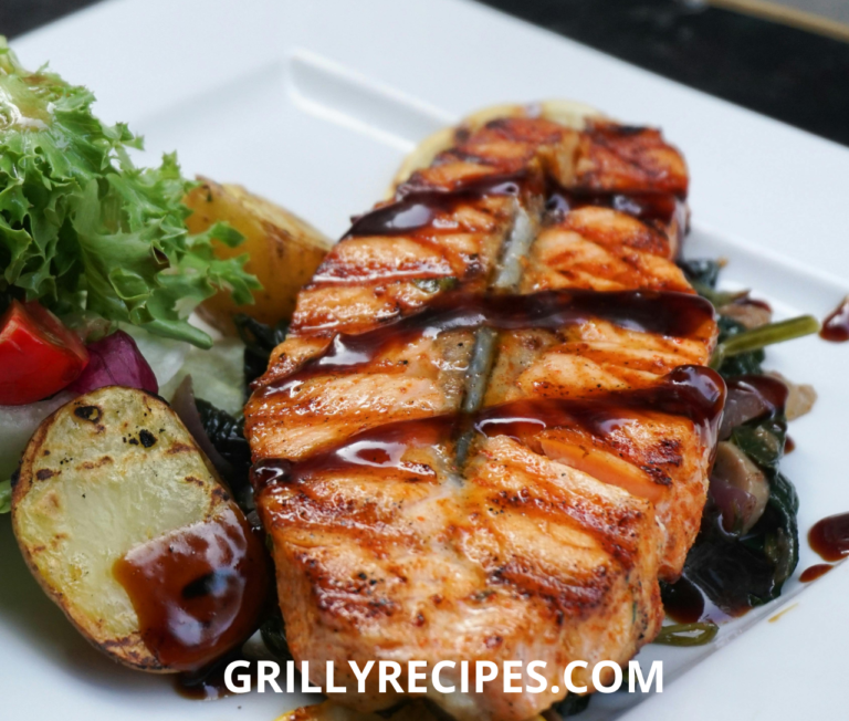 Grilled Tuna Steak Recipe with a savory sauce, served with roasted potatoes and fresh salad.