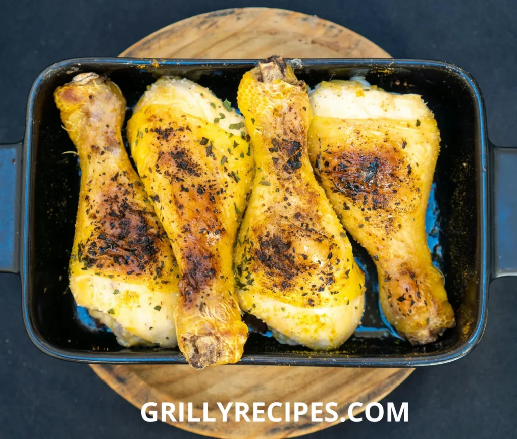 Juicy grilled chicken thighs with a golden-brown crust on a barbecue grill.