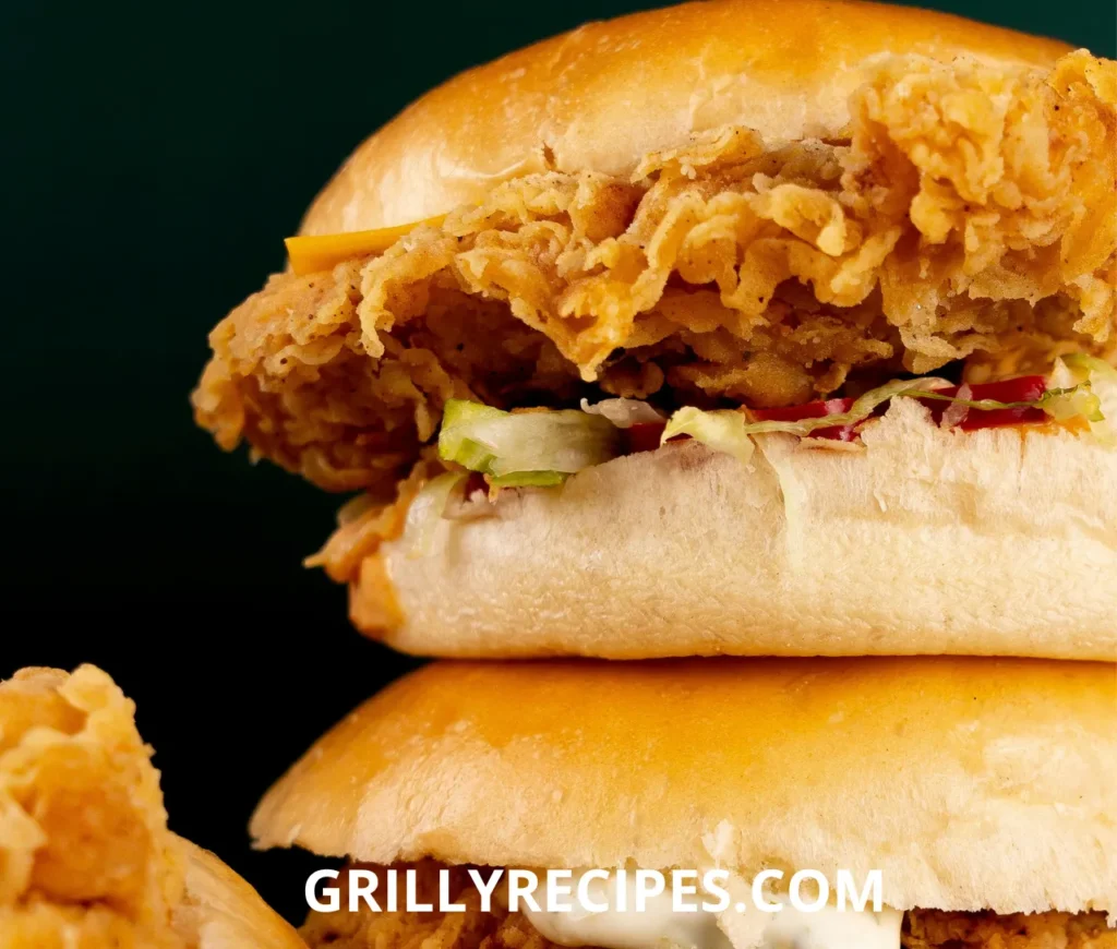 Juicy chicken sliders recipe​ with melted cheese, lettuce, and pickles on toasted slider buns.