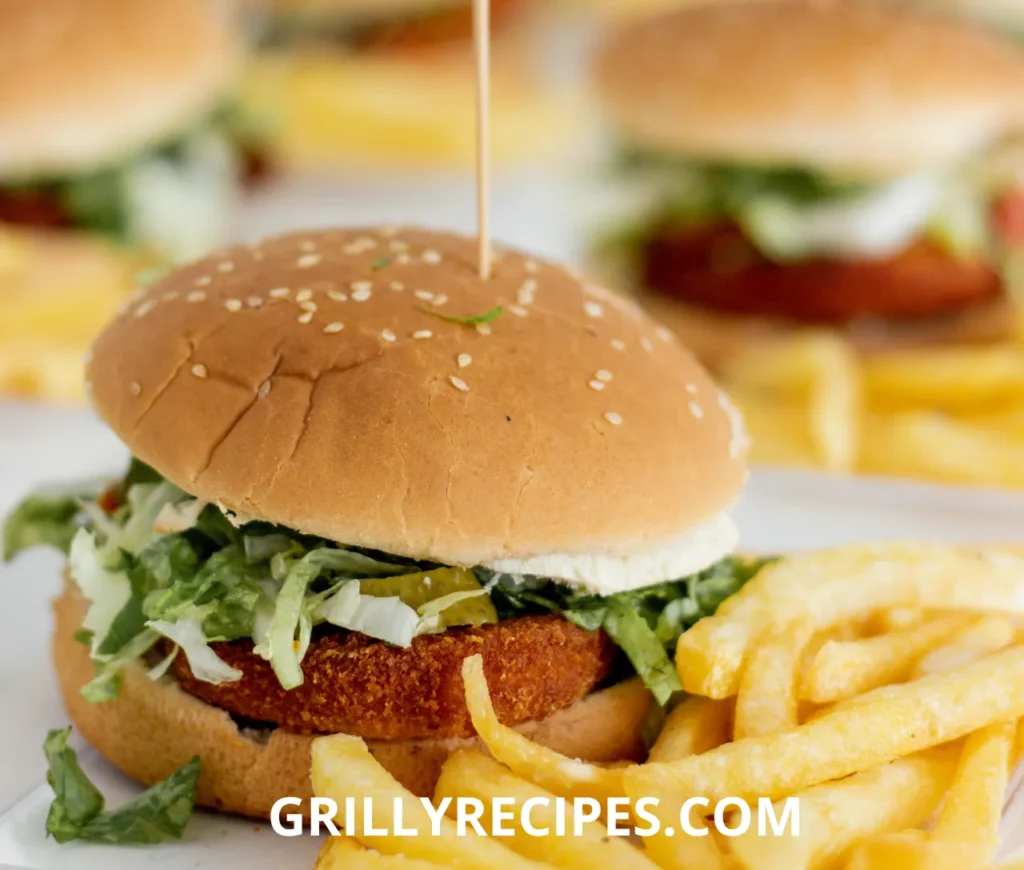 Juicy chicken sliders recipe​ with melted cheese, lettuce, and pickles on toasted slider buns.